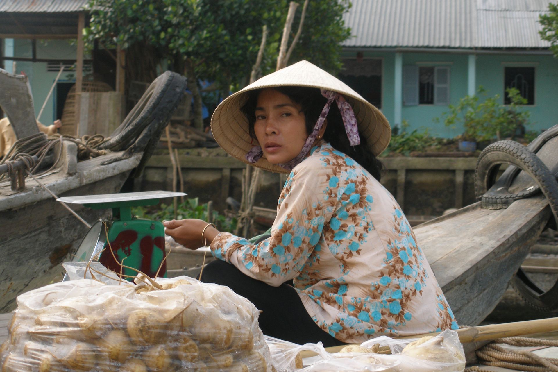 A vendor at a floating market in the Mekong Delta, Vietnam