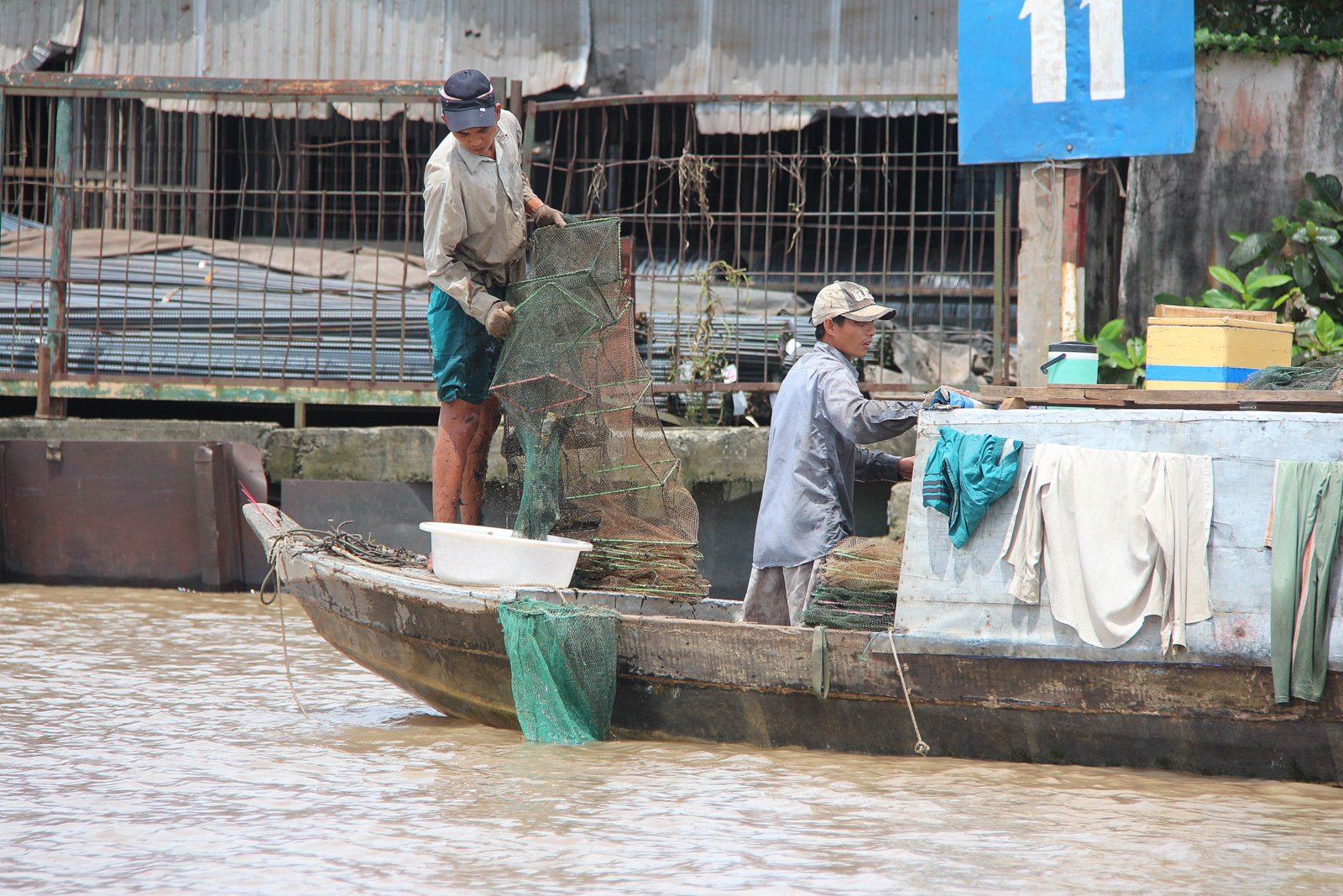 A fisherman emptying his net on the Mekong in Vietnam