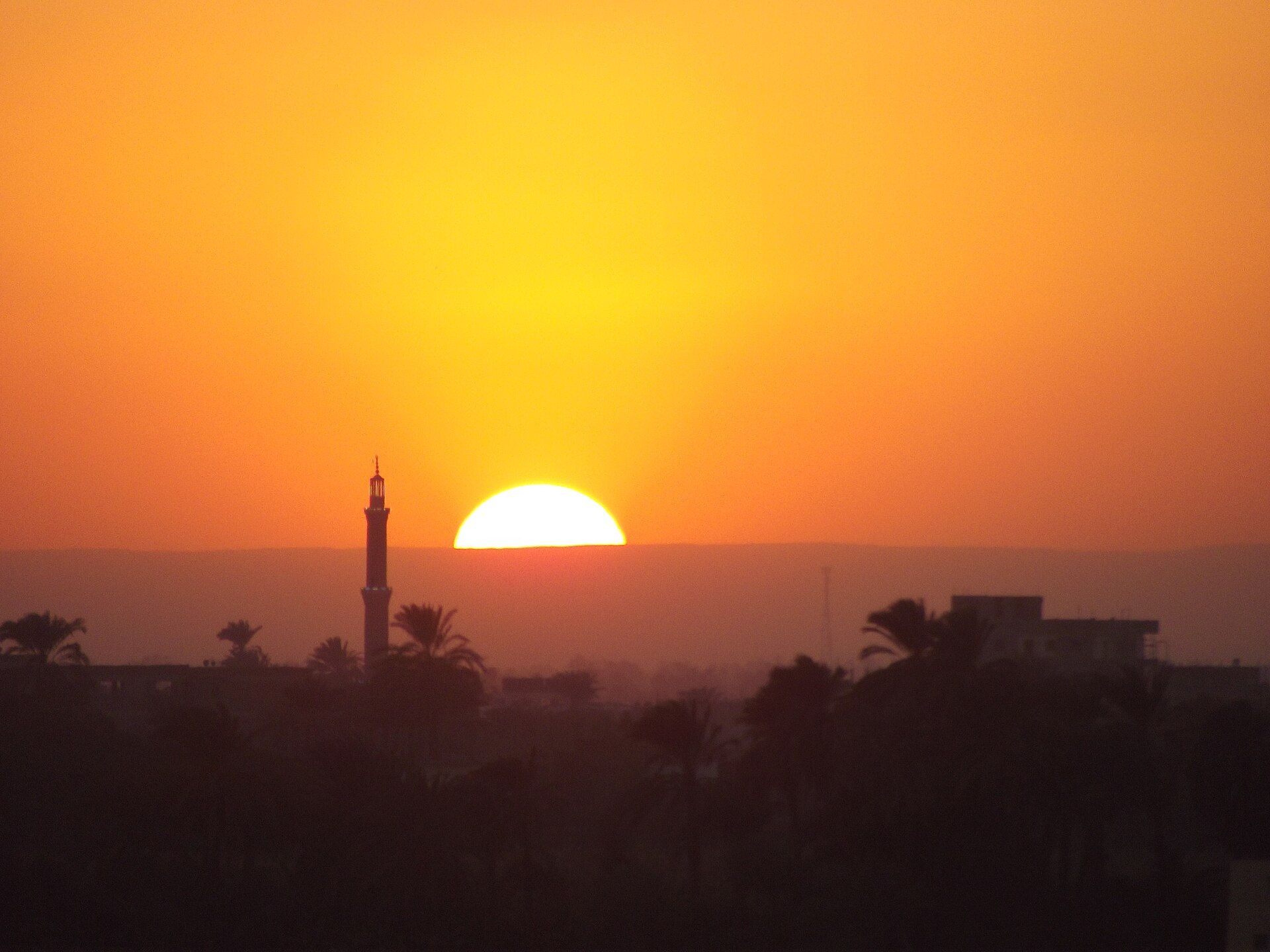 Sunset over the west bank of the Nile, a minaret in silhouette